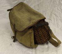 A fisherman's wicker creel with canvas and leather bag attachment