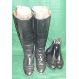 A pair of black leather riding boots with trees togehter with a pair of black leather Alfred