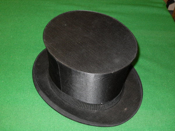 A black silk opera Hat with black band in carry box