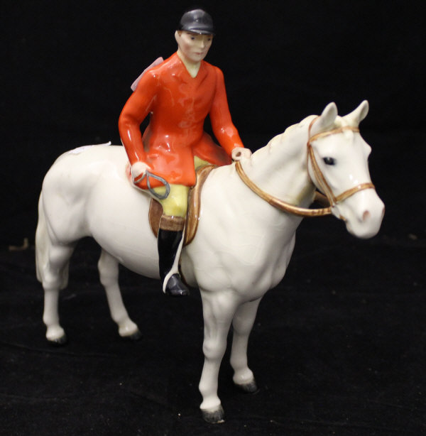 A Beswick figure of huntsman upon white horse CONDITION REPORTS Bradly crazed all