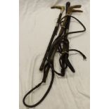 A leather covered bull whip with plaited leather thong,