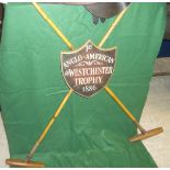 A reproduction Polo trophy in the form of two mallets crossing with shield shaped plaque inscribed