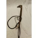 An ash riding crop with plaited leather thong,