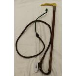 A child's riding crop with plastic antler effect handle and plaited leather shaft and thong