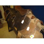 Two leather racing saddles,