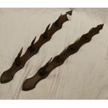 A pair of oak whip racks with antler mounts