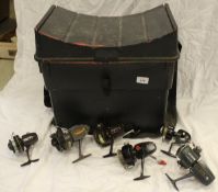 A fishing seat box containing a collection of assorted fishing reels to include fixed spool,