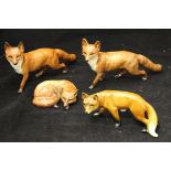 Three Beswick figures of foxes and one further West German figure of a fox