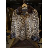 A mid 20th Century leopard jacket with mink collar inscribed "M. R. B.
