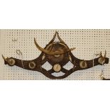 A carved wood and antler mounted coat and hat/whip rack