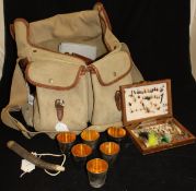 A Brady canvas and leather fishing bag containing a large quantity of fly cases and contents.