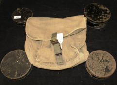 A collection of four Japaned cast dampers in various sizes and a canvas bag