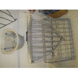 Two modern corner hay racks together with two modern hay feeders,