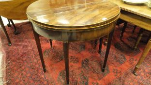 An early 19th Century mahogany tea table of demi-lune form,