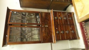 A 19th Century secretaire bookcase cabinet with two glazed doors above a four front compartment and