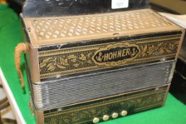 A Hohner accordion with embossed and gilded decoration and three boxes of 78's