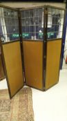 An early to mid 20th Century oak framed and leaded glazed three fold screen