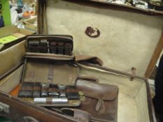 A heavy leather suitcase with remnants of label to interior,