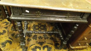 An oak single drawer side table on bobbin turned supports in the 17th Century manner