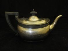 A silver teapot of rounded bellied form (Birmingham,