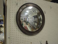 A HUGH WALLIS copper framed wall mirror with convex glass,