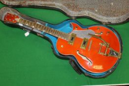 A semi acoustic electric guitar, bearing signature "Gretsch" with Bigsby tremolo,