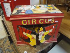 A modern hand painted "Circus" musical box and a three prong hay fork