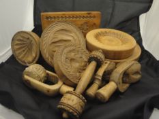 A large collection of mainly 19th Century carved treen ware butter moulds,