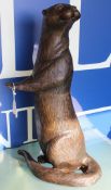 A modern chocolate brown patinated bronze figure of an otter upon it's haunches,