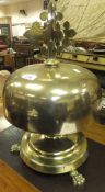 A large brass table top bell with cruciform surmount raised on paw feet