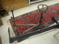 Two wrought iron andirons with ale mullers and a cast iron fire kerb CONDITION REPORTS