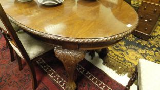 An Edwardian mahogany D end dining table with extra leaf,