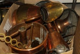 A box of copper and brass ware to include various jugs, pans,