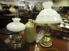 Two converted oil lamps and a stoneware jar