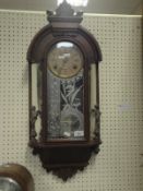 A late 19th Century Continental walnut cased hanging wall clock with transfer decorated glass