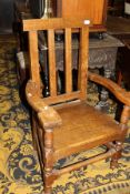 An oak panel seated elbow chair