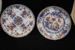 A 19th Century Chinese Imari shallow dish decorated with a vase of flowers and bamboo within a