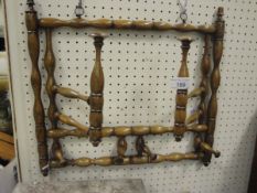 A circa 1900 stained beech bobbin turned adjustable hat and coat rack wall mounted