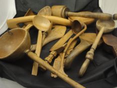 A large collection of mainly 19th Century treen ware to include 3 pestles, various bowls, spoons,