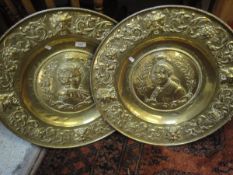 A pair of embossed brass chargers depicting Louis XVI and Marie Antoinette bearing date 1787