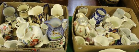 Two boxes containing various 19th Century and later pottery jugs