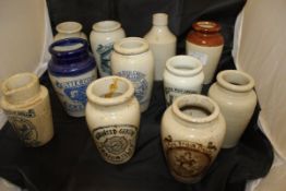 A collection of 11 various cream and other stoneware pots/bottles 5 stoneware jelly moulds and a