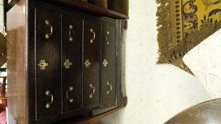 An 18th Century oak chest of drawers the plain top above four long drawers with fluted column