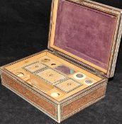 An early 20th Century Indian sandalwood and inlaid sarcophagus shaped work box with fitted interior