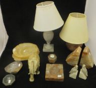 A collection of various carved stone items including elephant table lamps, bowls and ashtrays,