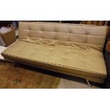 A modern gold leather upholstered sofa bed