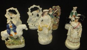 A collection of seven Victorian Staffordshire figures to include "Queen Victoria", "Ruth",