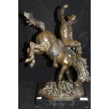 A modern bronze study of a rodeo rider on a black marble base