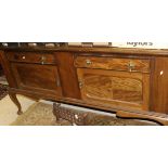 An early 20th Century mahogany sideboard with two drawers above two cupboard doors,