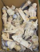 A box containing a collection of various late 19th / early 20th Century biscuit fired figures